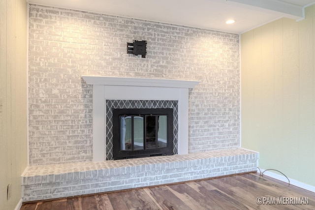 8220 Indian Shores Dr, Howard City, MI 49329 - detailed view of a glass covered fireplace, wood finished floors, and baseboards