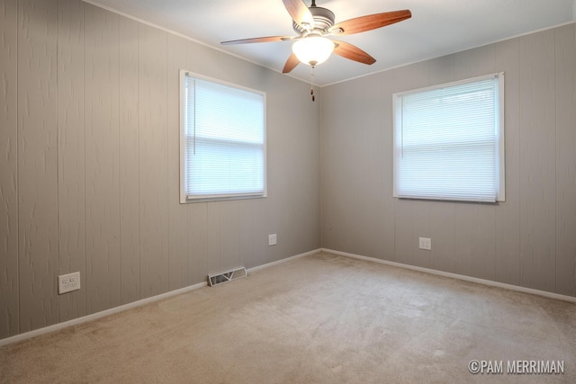 8220 Indian Shores Dr, Howard City, MI 49329 - carpeted spare room with ceiling fan, crown molding, baseboards, and wooden walls
