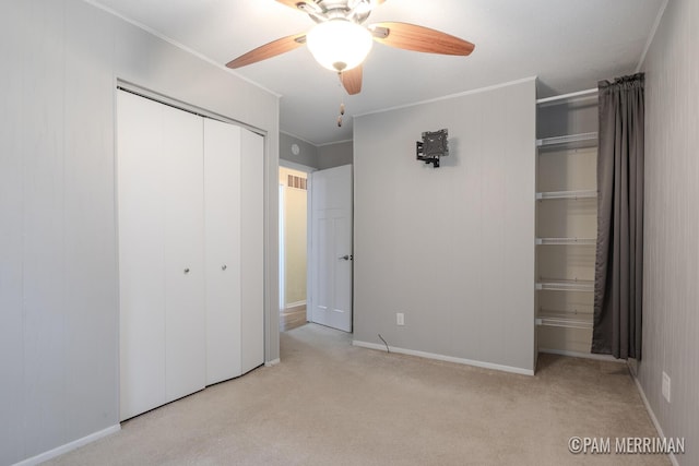 8220 Indian Shores Dr, Howard City, MI 49329 - unfurnished bedroom featuring carpet flooring, a closet, ornamental molding, a ceiling fan, and baseboards