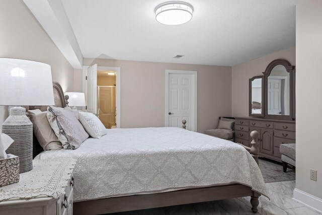 4624 Parman Rd, Stockbridge, MI 49285 - bedroom featuring light marble finish flooring, connected bathroom, and baseboards