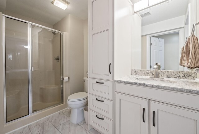 4624 Parman Rd, Stockbridge, MI 49285 - bathroom with toilet, a stall shower, marble look tile flooring, and vanity