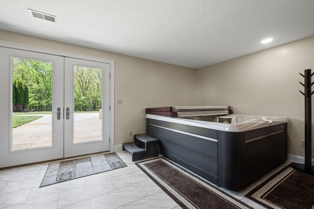 4624 Parman Rd, Stockbridge, MI 49285 - doorway with french doors, marble look tile flooring, a textured ceiling, and baseboards