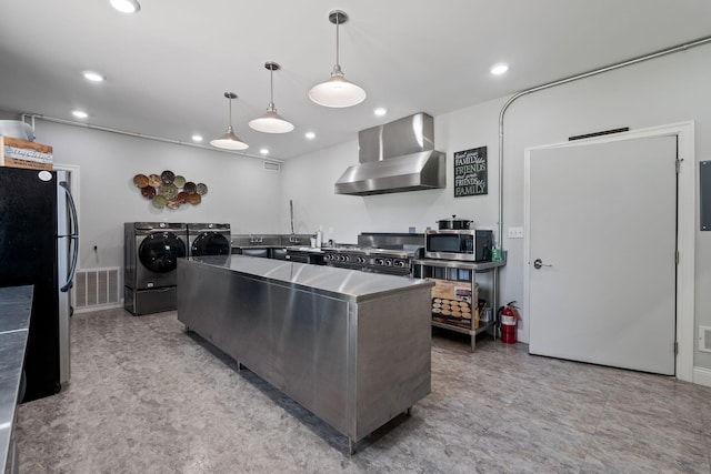 4624 Parman Rd, Stockbridge, MI 49285 - kitchen with washing machine and clothes dryer, wall chimney exhaust hood, stainless steel appliances, a center island, and recessed lighting
