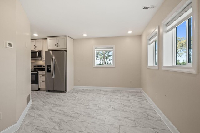 4624 Parman Rd, Stockbridge, MI 49285 - kitchen featuring stainless steel appliances, light marble finish floors, white cabinetry, baseboards, and recessed lighting