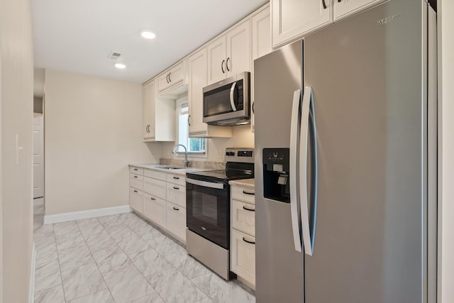 4624 Parman Rd, Stockbridge, MI 49285 - kitchen with stainless steel appliances, a sink, light marble finish floors, light countertops, and white cabinets