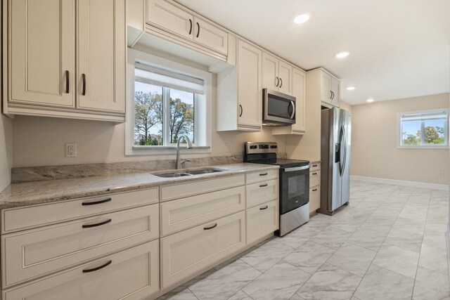 4624 Parman Rd, Stockbridge, MI 49285 - kitchen with appliances with stainless steel finishes, light marble finish floors, a sink, recessed lighting, and baseboards