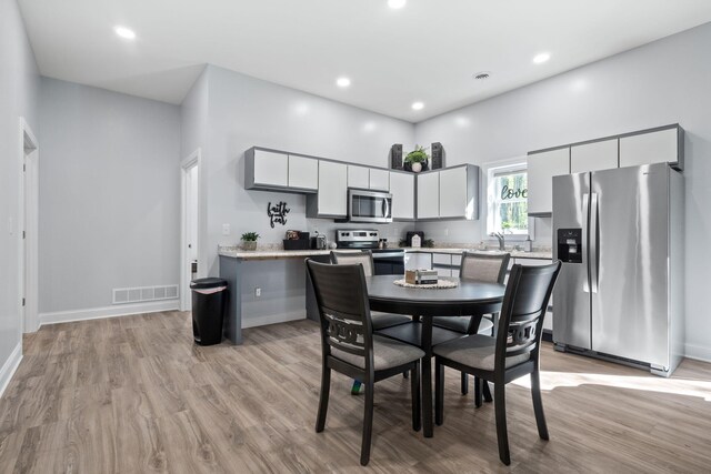 4624 Parman Rd, Stockbridge, MI 49285 - dining area featuring light wood finished floors, baseboards, and recessed lighting