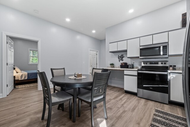 4624 Parman Rd, Stockbridge, MI 49285 - kitchen featuring stainless steel appliances, light countertops, white cabinets, light wood-style floors, and recessed lighting