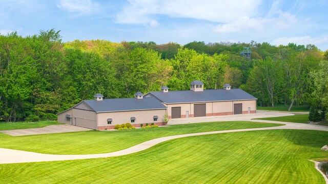 4624 Parman Rd, Stockbridge, MI 49285 - view of front of home featuring a front lawn and a detached garage