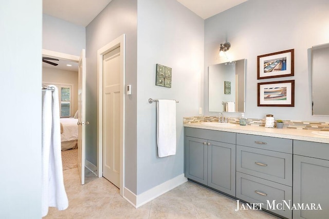 2078 Chippewa Dr Unit 25, Holland, MI 49424 - ensuite bathroom with double vanity, baseboards, tile patterned floors, and a ceiling fan