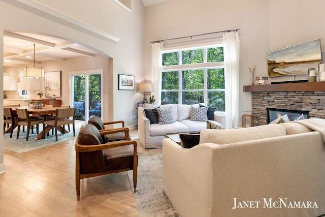 2078 Chippewa Dr Unit 25, Holland, MI 49424 - living area with arched walkways, healthy amount of natural light, coffered ceiling, wood finished floors, and beamed ceiling