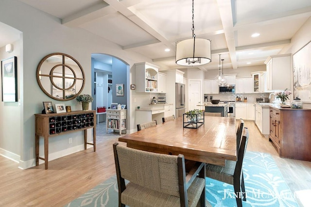 2078 Chippewa Dr Unit 25, Holland, MI 49424 - dining area with coffered ceiling, light wood-style flooring, arched walkways, beam ceiling, and recessed lighting