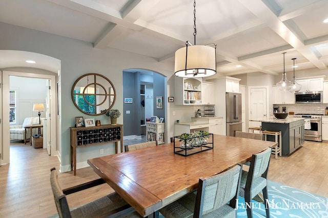 2078 Chippewa Dr Unit 25, Holland, MI 49424 - dining space featuring arched walkways, coffered ceiling, light wood-style floors, beam ceiling, and recessed lighting