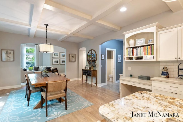 2078 Chippewa Dr Unit 25, Holland, MI 49424 - dining area with arched walkways, coffered ceiling, light wood-type flooring, baseboards, and beam ceiling