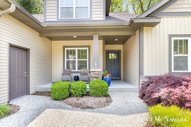 2078 Chippewa Dr Unit 25, Holland, MI 49424 - entrance to property featuring a porch, a shingled roof, and board and batten siding