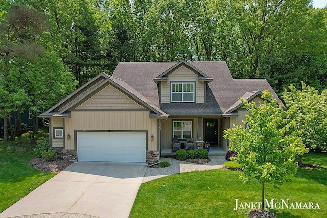 2078 Chippewa Dr Unit 25, Holland, MI 49424 - craftsman house featuring a garage, covered porch, driveway, a front lawn, and stone siding
