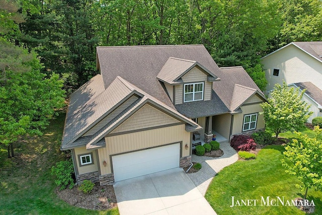 2078 Chippewa Dr Unit 25, Holland, MI 49424 - craftsman house with a garage, driveway, a shingled roof, and stone siding