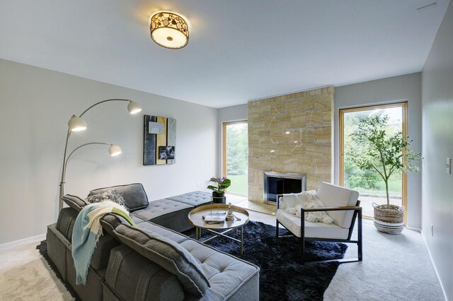 843 Greenhills Dr, Ann Arbor, MI 48105 - living room featuring light carpet, a stone fireplace, and baseboards