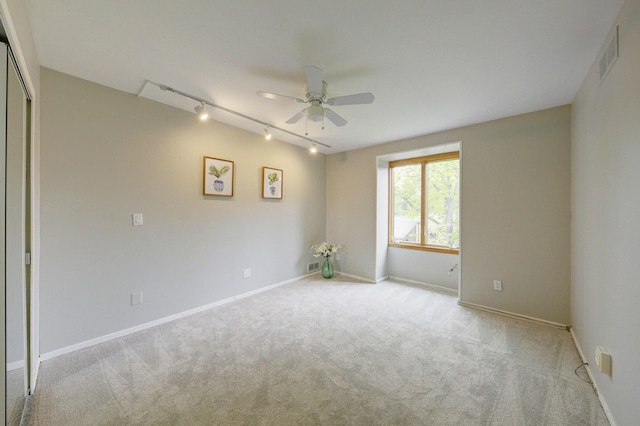 843 Greenhills Dr, Ann Arbor, MI 48105 - carpeted empty room with track lighting, a ceiling fan, and baseboards