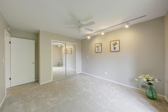843 Greenhills Dr, Ann Arbor, MI 48105 - unfurnished bedroom with track lighting, carpet floors, a closet, ceiling fan, and baseboards