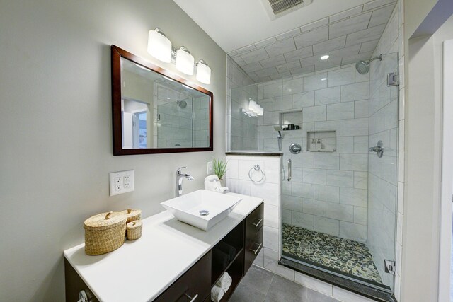 843 Greenhills Dr, Ann Arbor, MI 48105 - bathroom with a stall shower, vanity, and tile patterned flooring