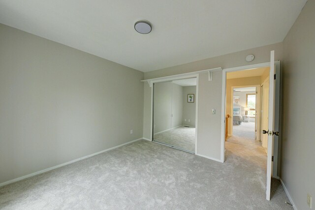 843 Greenhills Dr, Ann Arbor, MI 48105 - unfurnished bedroom featuring light colored carpet, baseboards, and a closet