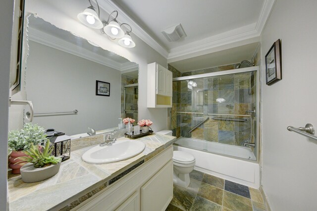 843 Greenhills Dr, Ann Arbor, MI 48105 - full bathroom featuring ornamental molding, vanity, toilet, shower / bath combination with glass door, and stone finish flooring