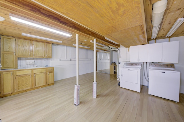 843 Greenhills Dr, Ann Arbor, MI 48105 - laundry area with independent washer and dryer, cabinet space, light wood-type flooring, and wood ceiling