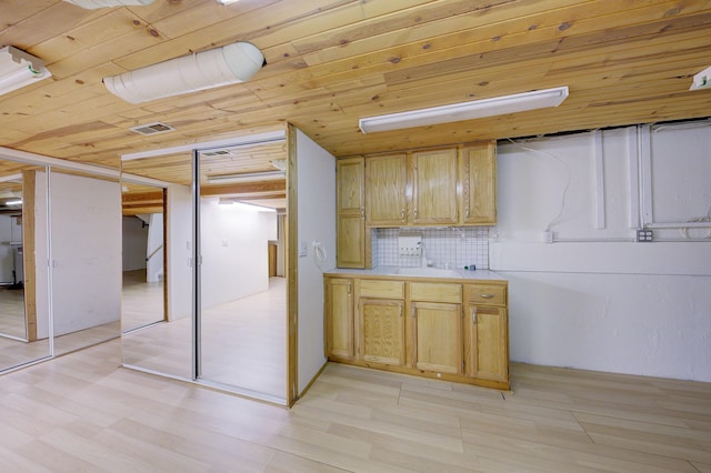 843 Greenhills Dr, Ann Arbor, MI 48105 - kitchen featuring wooden ceiling, light countertops, light wood finished floors, decorative backsplash, and a sink