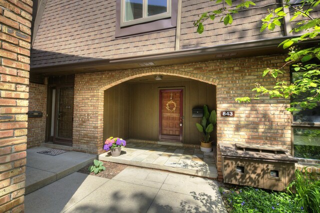 843 Greenhills Dr, Ann Arbor, MI 48105 - property entrance featuring brick siding and a shingled roof