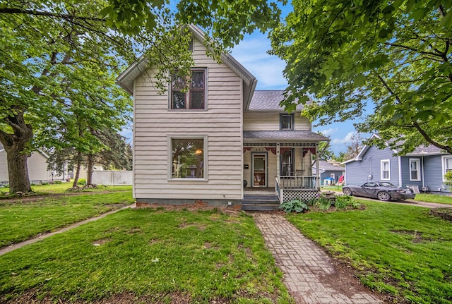 237 E Main St, Milan, MI 48160 - traditional home with a porch, a front yard, and a shingled roof