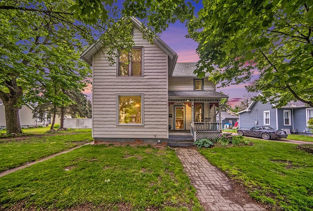 237 E Main St, Milan, MI 48160 - traditional-style house with a porch, a front yard, and roof with shingles