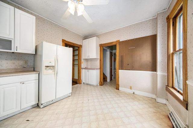 237 E Main St, Milan, MI 48160 - kitchen featuring white appliances, wallpapered walls, light flooring, a baseboard radiator, and ceiling fan