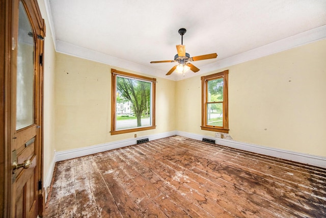 237 E Main St, Milan, MI 48160 - empty room featuring hardwood / wood-style floors, baseboards, crown molding, and a ceiling fan