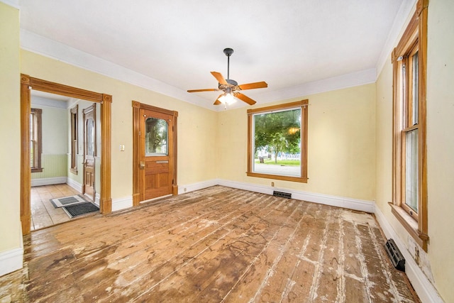 237 E Main St, Milan, MI 48160 - spare room featuring a ceiling fan, baseboards, hardwood / wood-style flooring, and ornamental molding