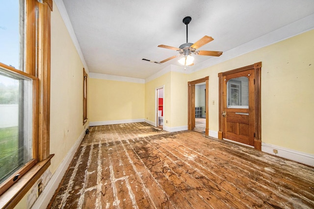 237 E Main St, Milan, MI 48160 - empty room featuring healthy amount of natural light, crown molding, hardwood / wood-style floors, and baseboards