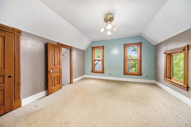 237 E Main St, Milan, MI 48160 - additional living space with vaulted ceiling, light carpet, ceiling fan, and baseboards
