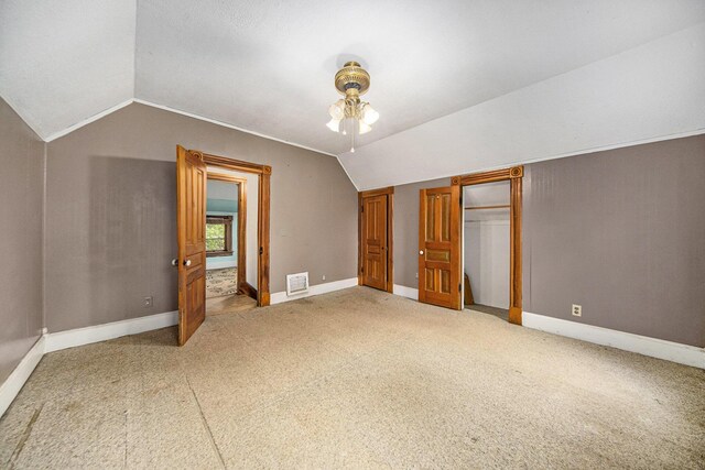 237 E Main St, Milan, MI 48160 - unfurnished bedroom featuring lofted ceiling, carpet, and baseboards