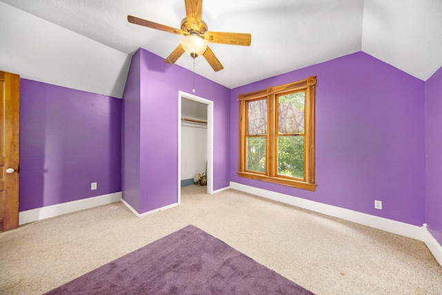 237 E Main St, Milan, MI 48160 - unfurnished bedroom featuring vaulted ceiling, carpet, a closet, baseboards, and ceiling fan