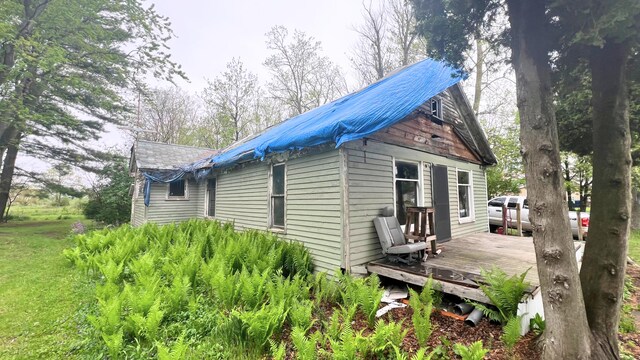 8059 N Wheeler Rd, Wheeler, MI 48662 - view of side of home with a wooden deck and metal roof