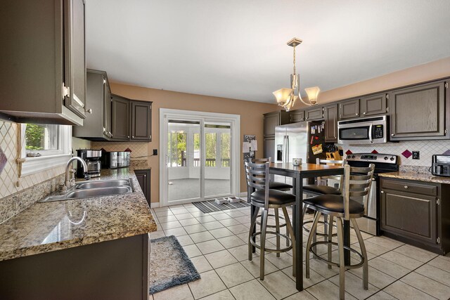 17270 Taft Rd, Spring Lake, MI 49456 - kitchen with appliances with stainless steel finishes, a sink, backsplash, and light tile patterned floors