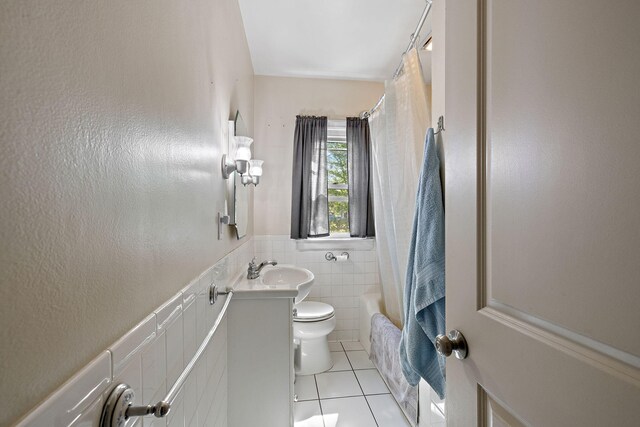17270 Taft Rd, Spring Lake, MI 49456 - full bathroom with tile patterned floors, toilet, vanity, tile walls, and wainscoting