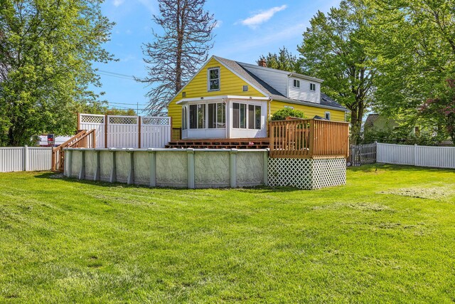 17270 Taft Rd, Spring Lake, MI 49456 - rear view of house featuring a wooden deck, a shingled roof, and a sunroom