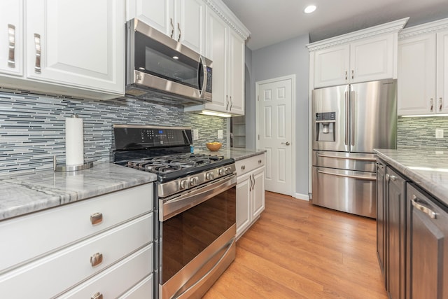 1218 Waterways Dr, Ann Arbor, MI 48108 - kitchen featuring appliances with stainless steel finishes, white cabinetry, recessed lighting, light wood finished floors, and decorative backsplash