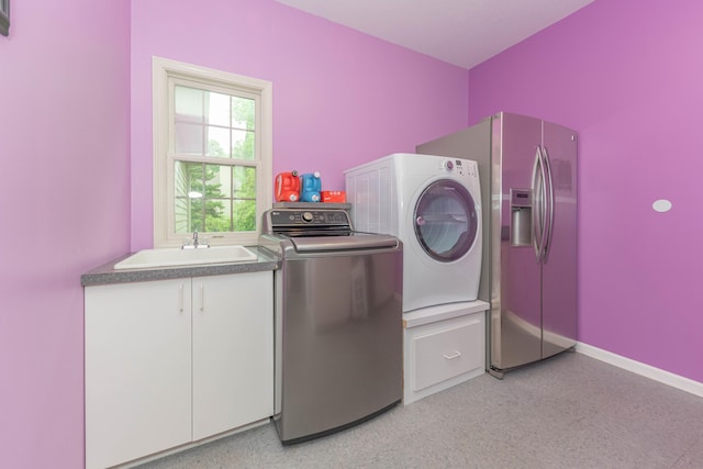 1218 Waterways Dr, Ann Arbor, MI 48108 - washroom with washer and clothes dryer, cabinet space, and baseboards