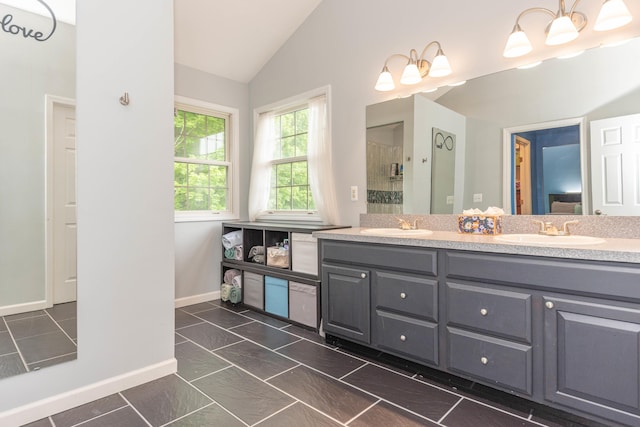 1218 Waterways Dr, Ann Arbor, MI 48108 - bathroom with lofted ceiling, a stall shower, baseboards, and double vanity