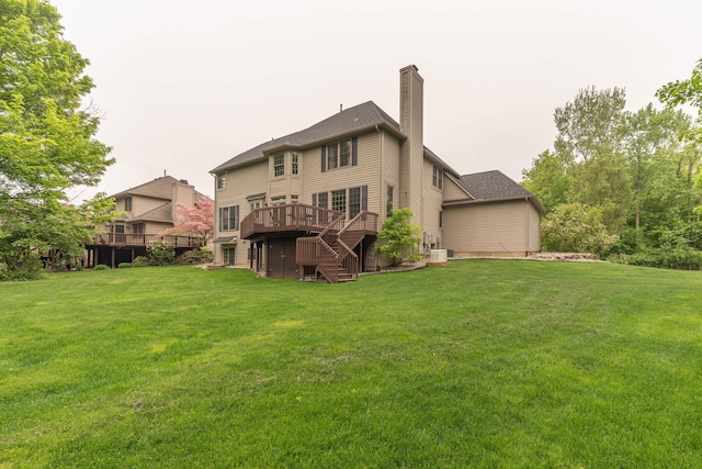 1218 Waterways Dr, Ann Arbor, MI 48108 - rear view of property featuring a wooden deck, a chimney, a lawn, and stairs