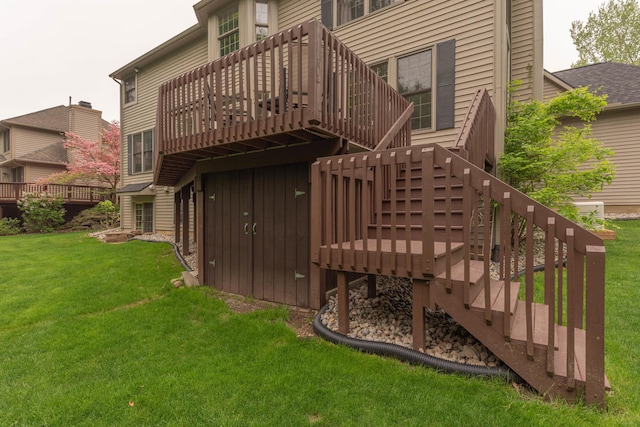 1218 Waterways Dr, Ann Arbor, MI 48108 - back of property with stairway, a wooden deck, and a lawn