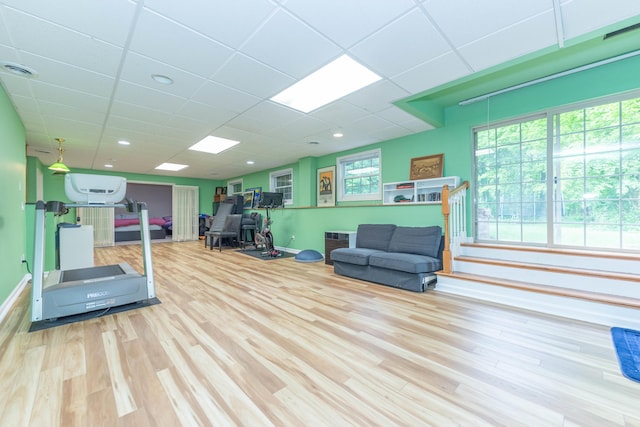 1218 Waterways Dr, Ann Arbor, MI 48108 - workout room with wood finished floors, baseboards, and a drop ceiling