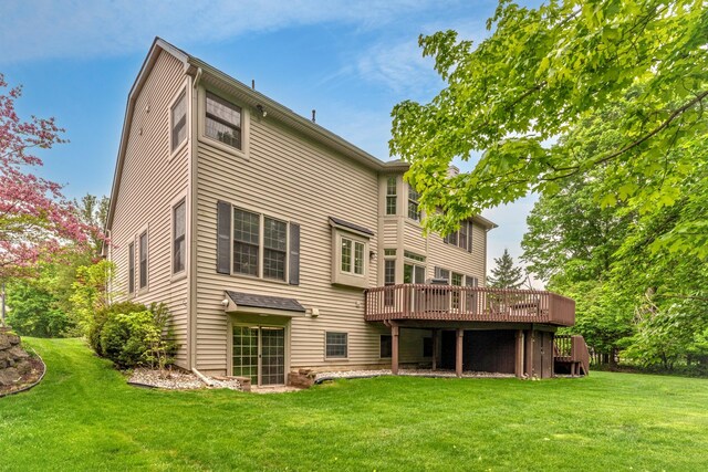 1218 Waterways Dr, Ann Arbor, MI 48108 - back of house featuring a deck and a lawn